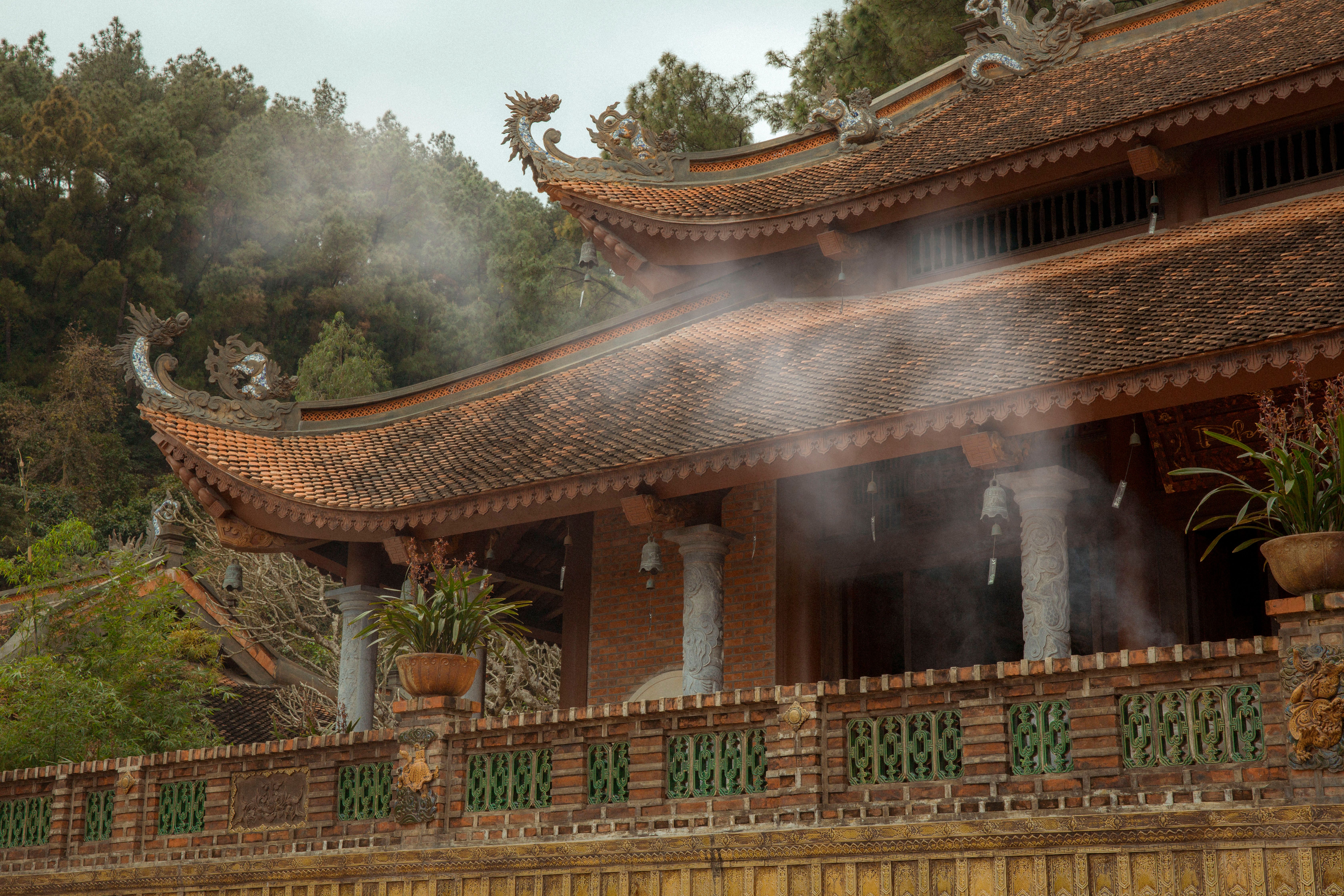 Vietnamese temple in morning mist with sunbeams
